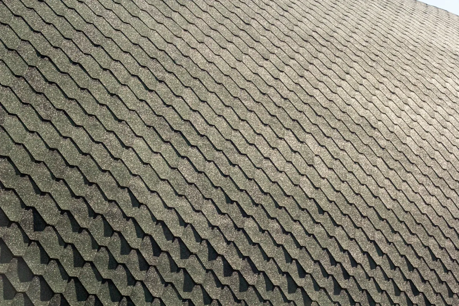 A close view across the asphalt shingles of a residential roof